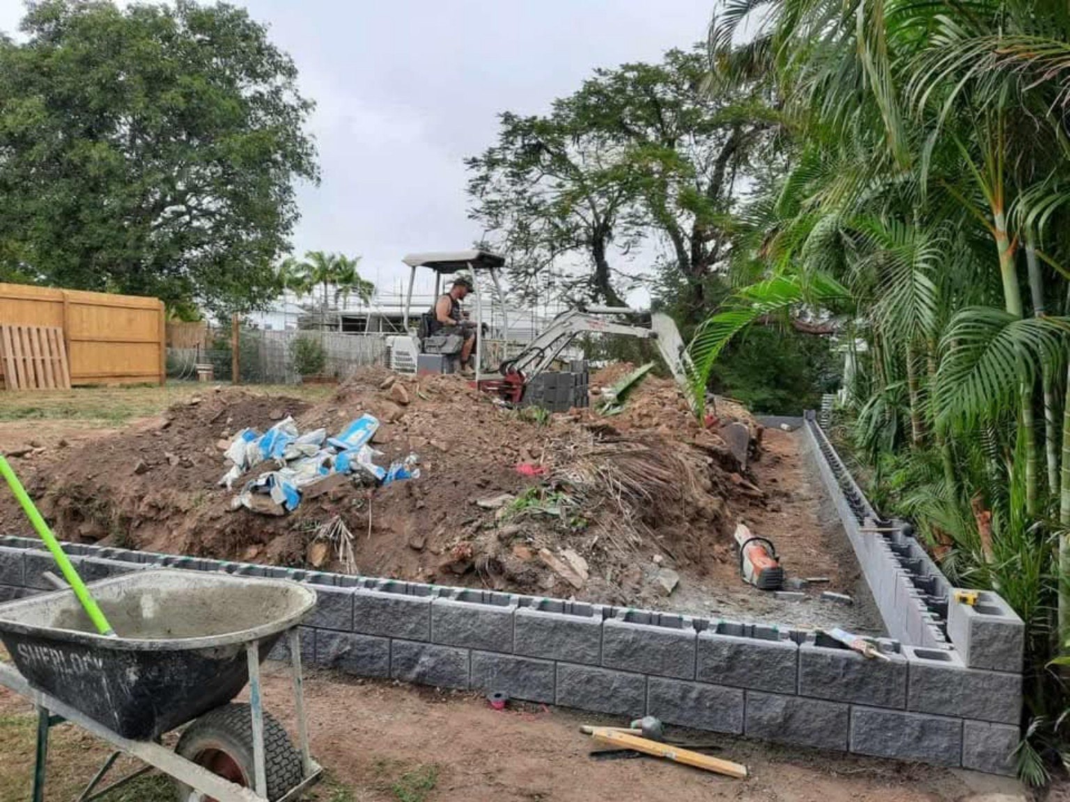 Excavator completing backyard earthworks