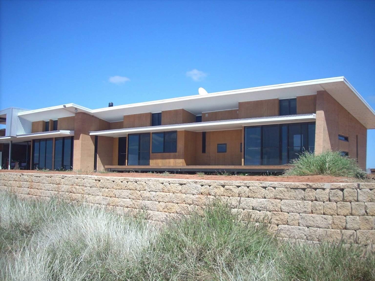 Modern home with retaining wall landscaping