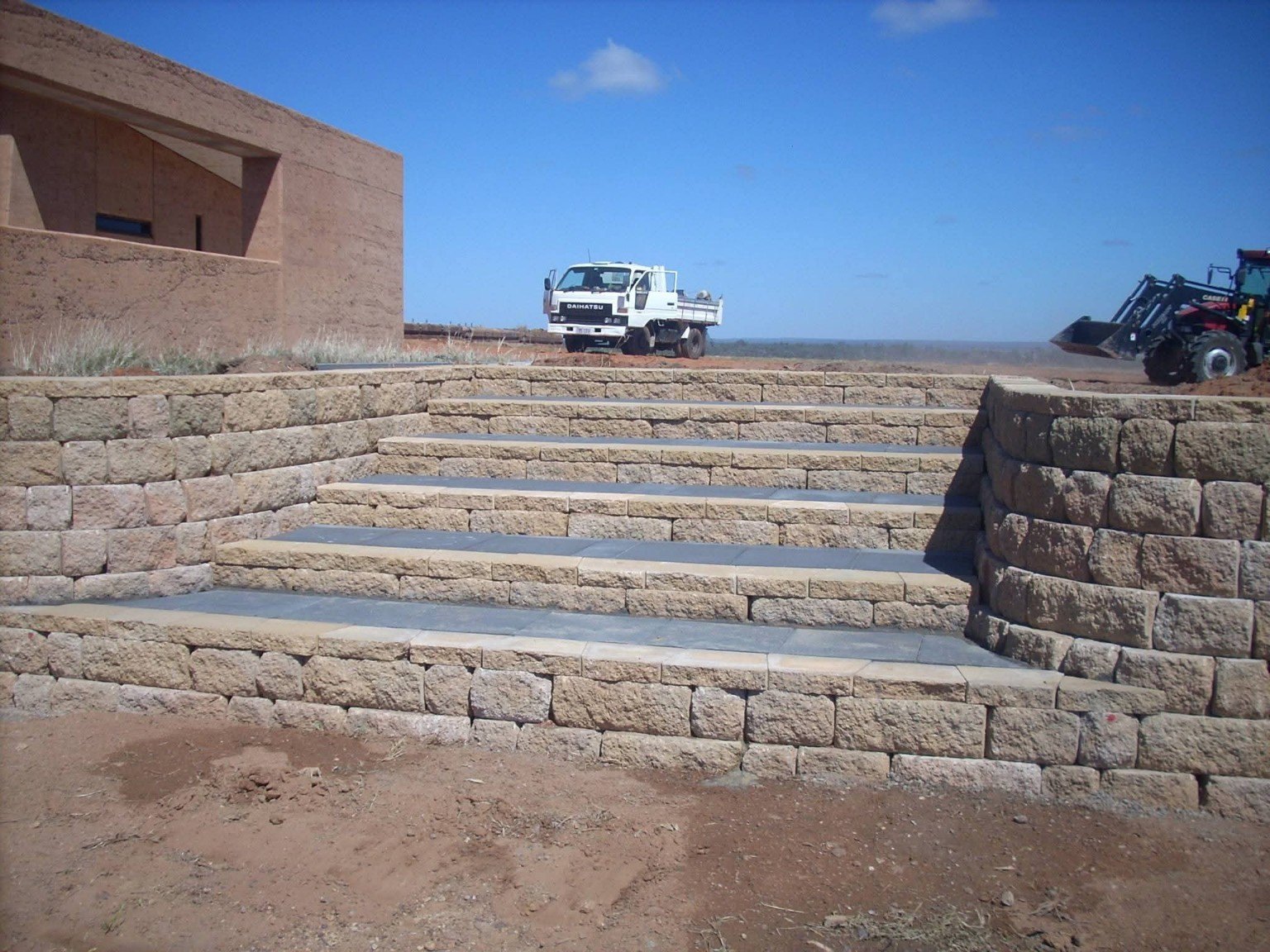 Retaining wall at sunset on large property
